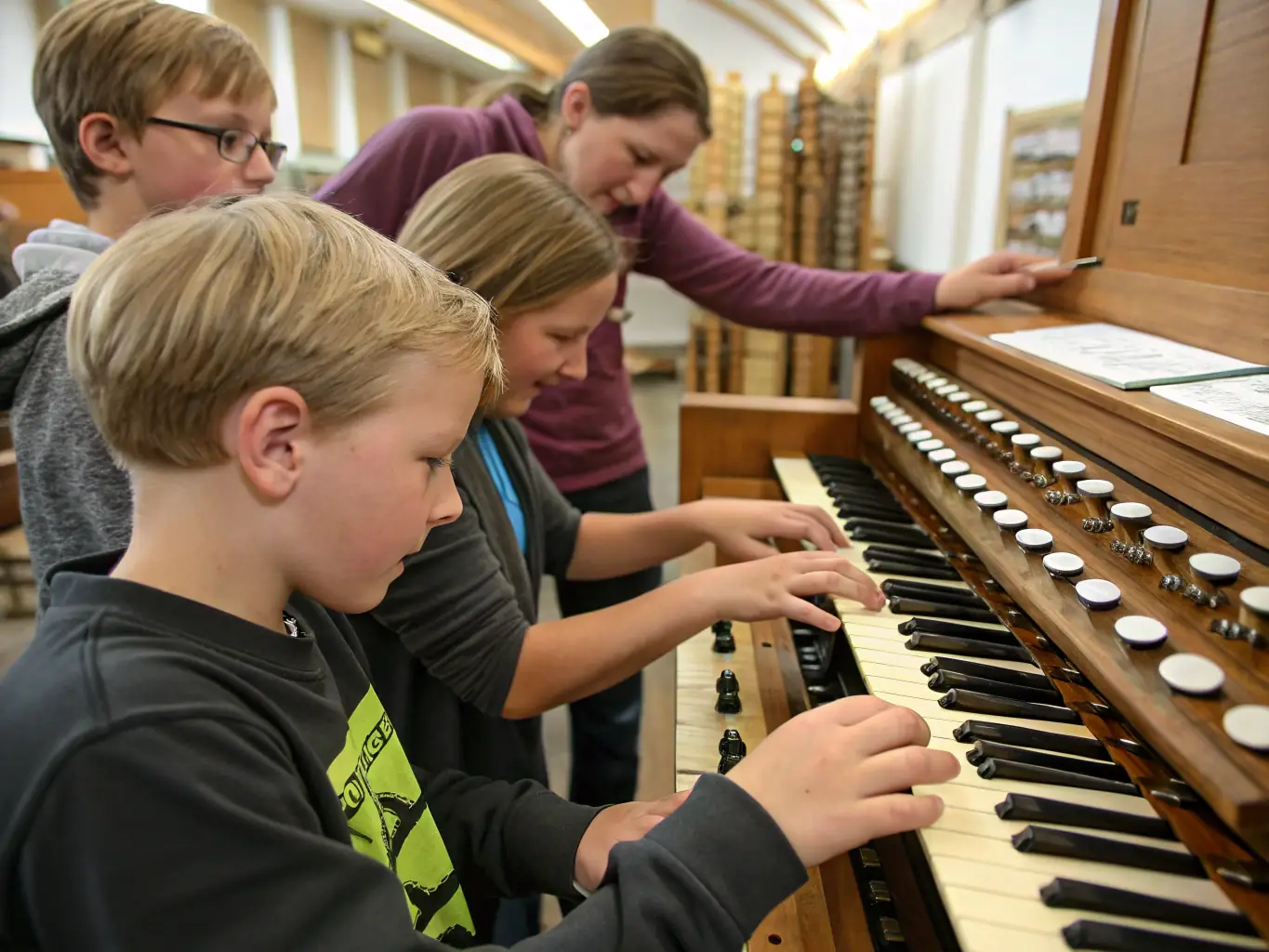 A photograph of an organist performing at the Rodez Cathedral, bathed in soft, golden light, capturing the grandeur of the instrument and the solemnity of the setting. The audience is blurred in the background, focusing on the musician's hands on the keys.