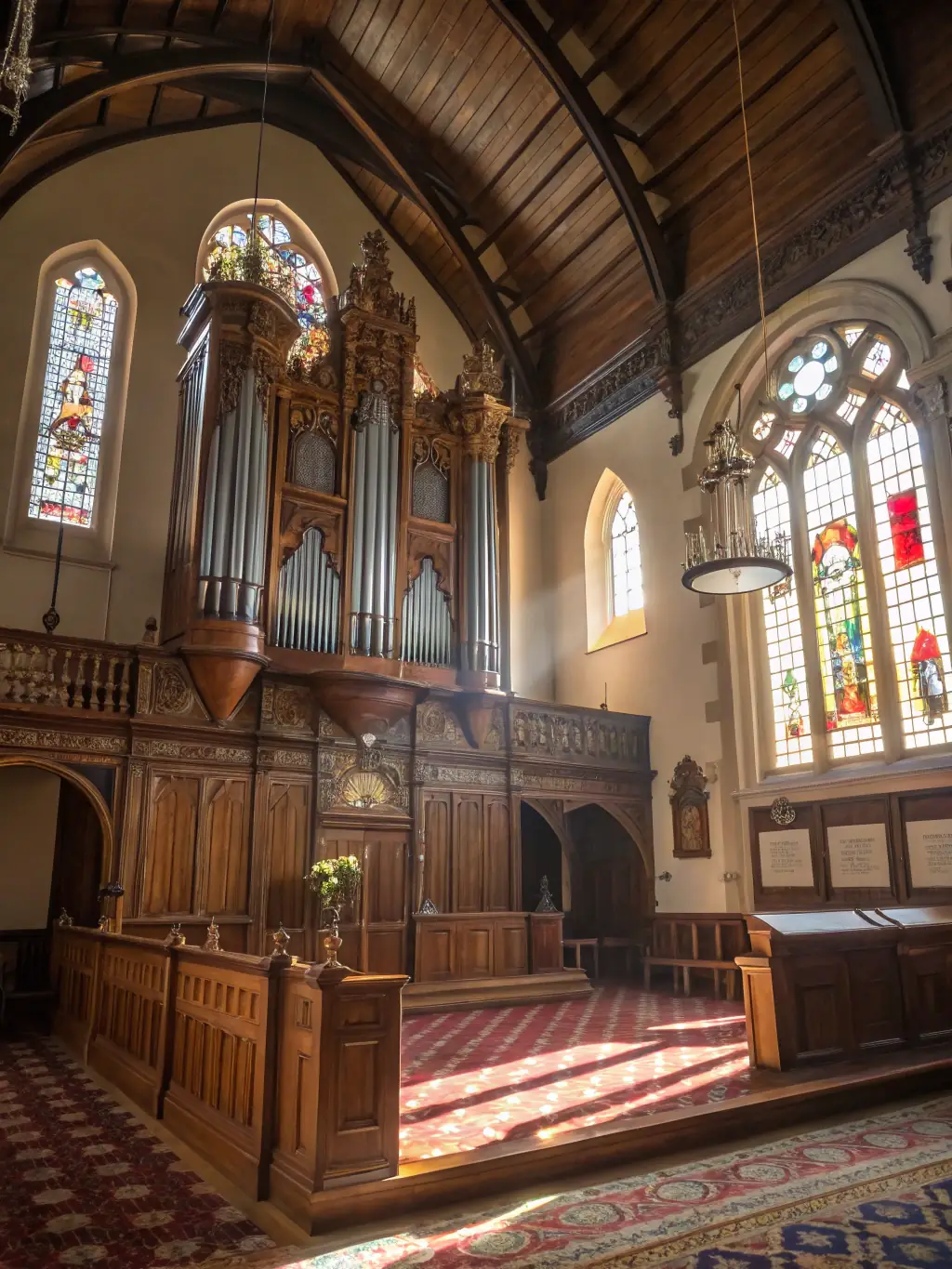 A wide shot of a historic church interior, showcasing the architectural grandeur and the placement of the organ within the space.